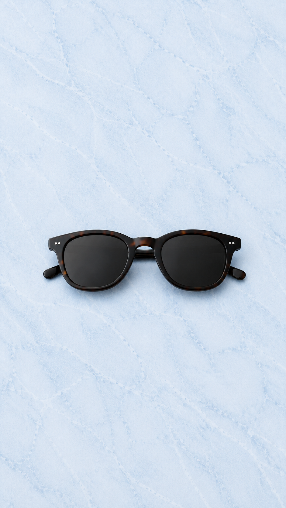 REUT Amalfi tortoise sunglasses on light blue marble